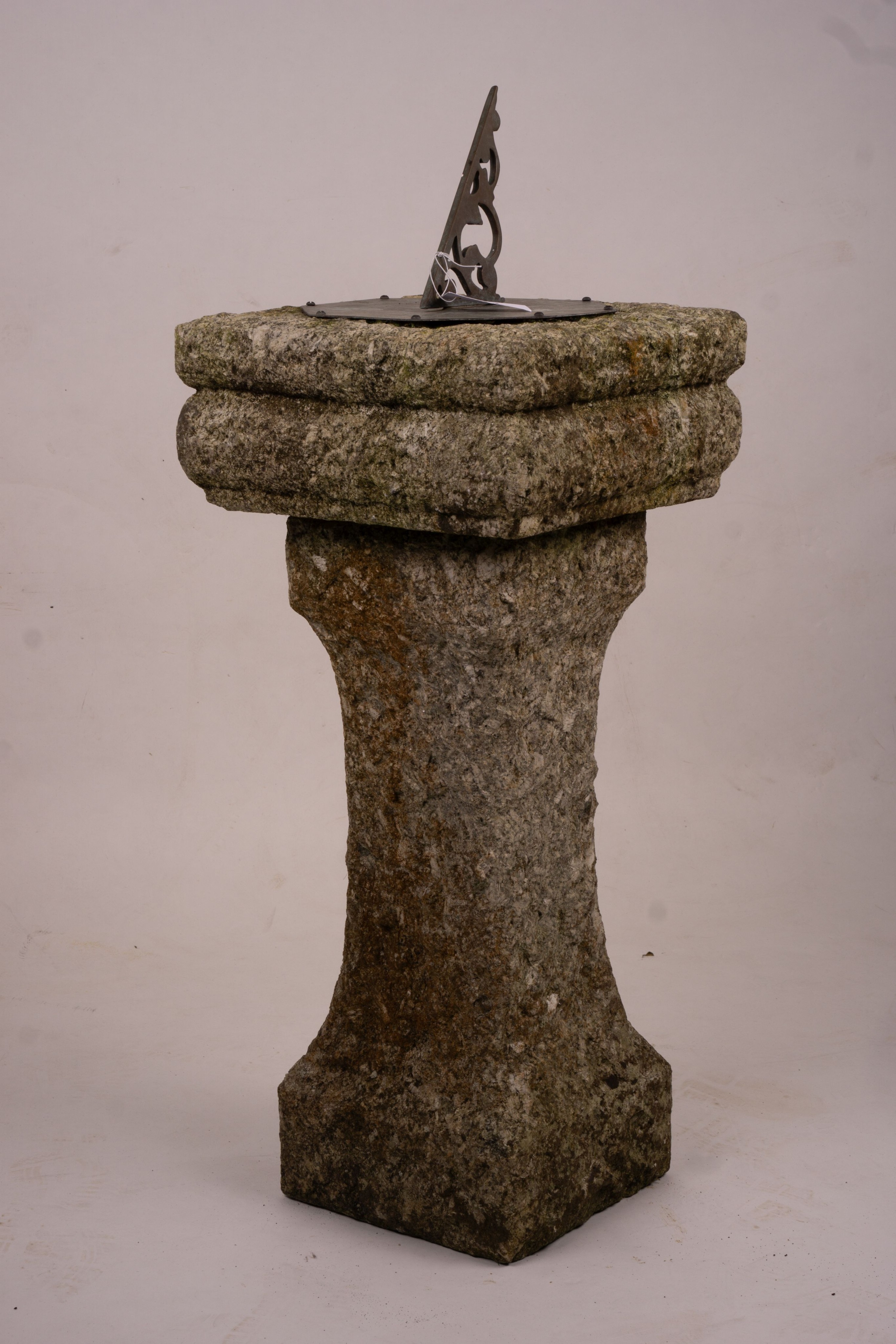 An octagonal sundial on reconstituted stone plinth, height 92cm